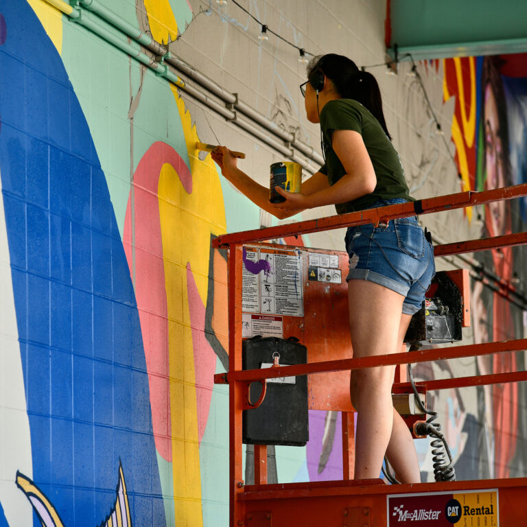 Students Finish Installment of Groovy Opportunity Mural Under Hamster Cage Garage